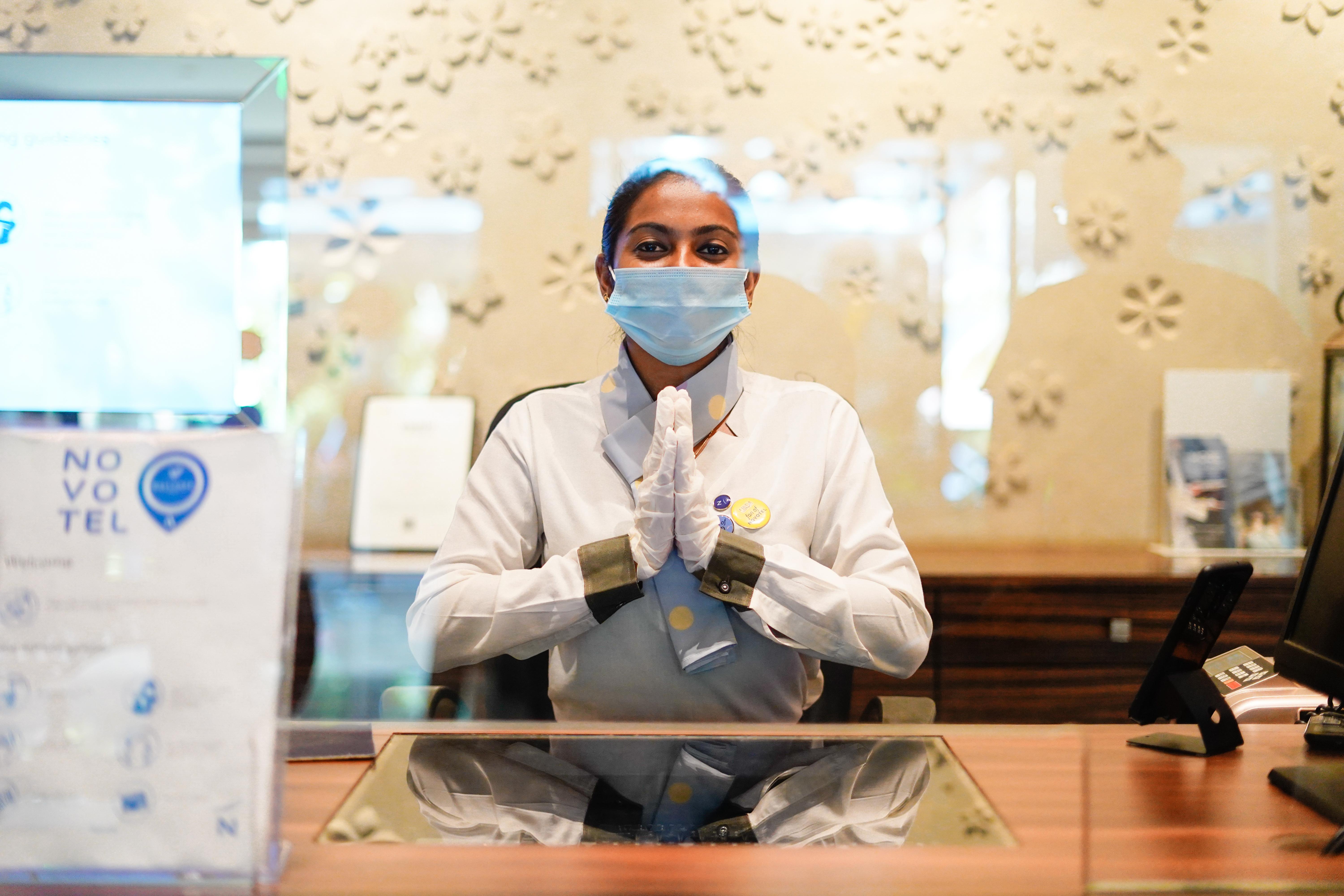 Novotel Goa Resort & Spa Candolim Extérieur photo A hotel employee wearing a face mask